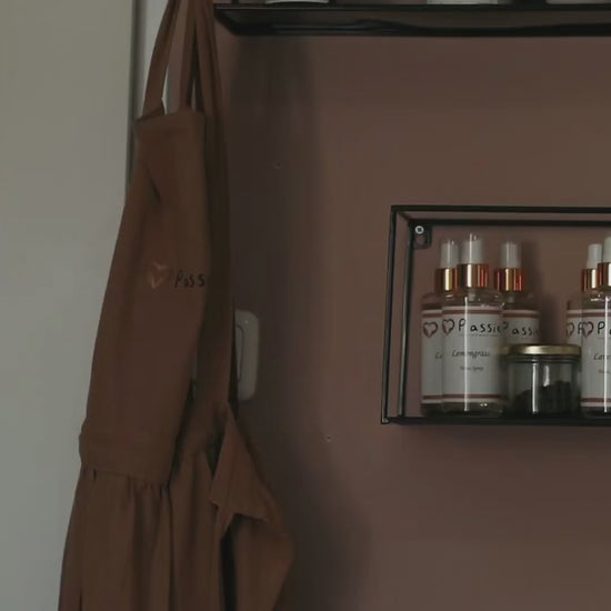 Video demonstrating the manual essential oil bottling process: carefully filling glass bottles with essential oil, securing the caps, and applying labels by hand.