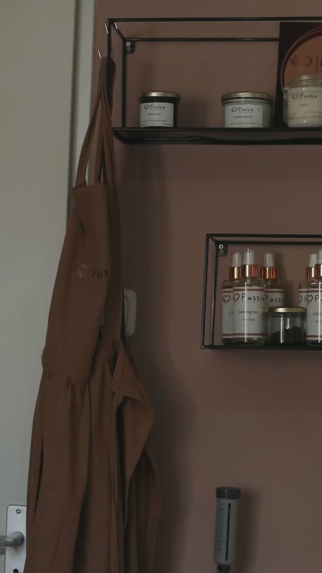 Video demonstrating the manual essential oil bottling process: carefully filling glass bottles with essential oil, securing the caps, and applying labels by hand.